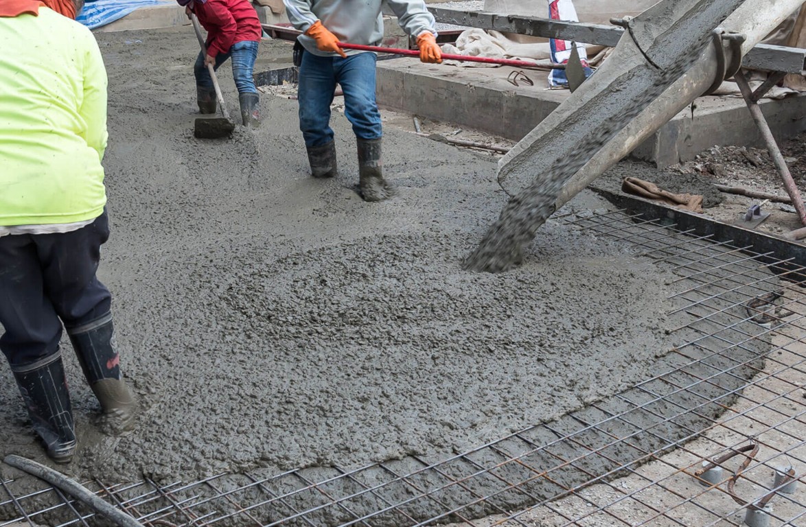 Professional concrete contractor pouring slab with proper equipment in Alexandria, LA
